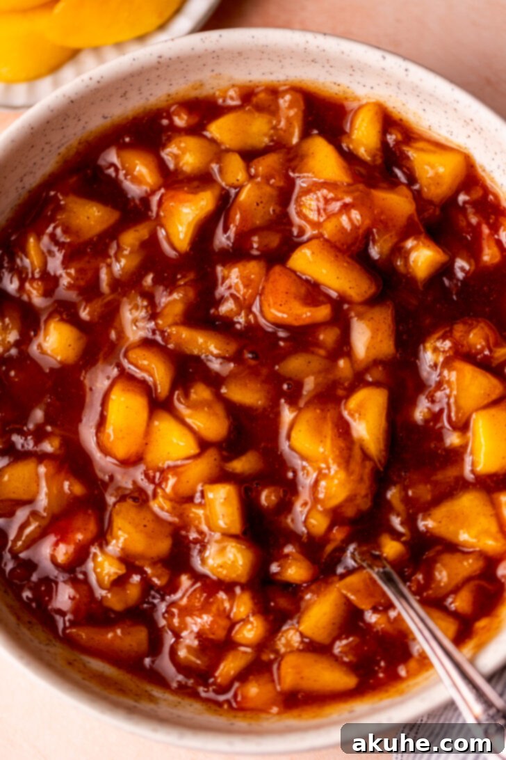Delectable Peach Cobbler Cookies 9 Close-up top view of bubbling peach filling thickening in a saucepan.