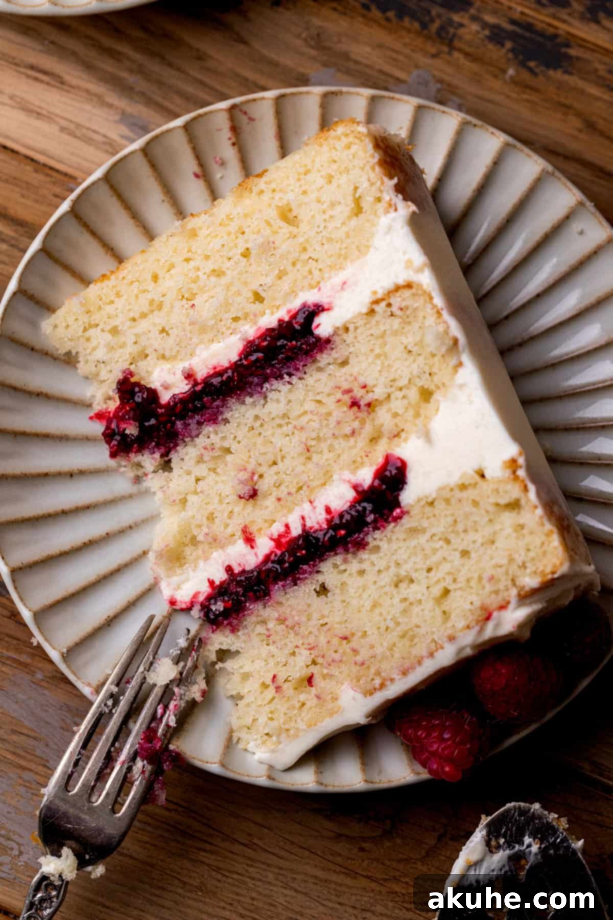 Top view of a perfectly sliced white chocolate raspberry cake, ready to be served.
