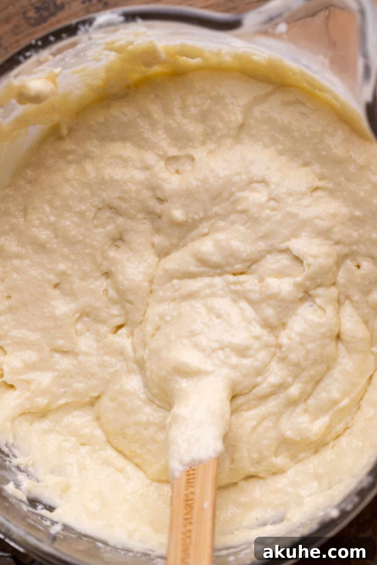 Vanilla cake batter with a smooth, creamy texture in a glass bowl.