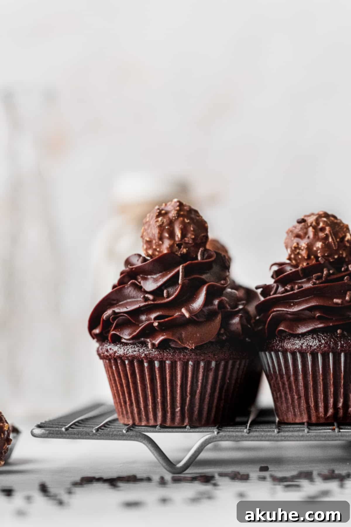 Decadent Chocolate Fudge Cupcakes 2 Decadent Chocolate Fudge Cupcakes cooling on a wire rack, showcasing their rich color and inviting texture.