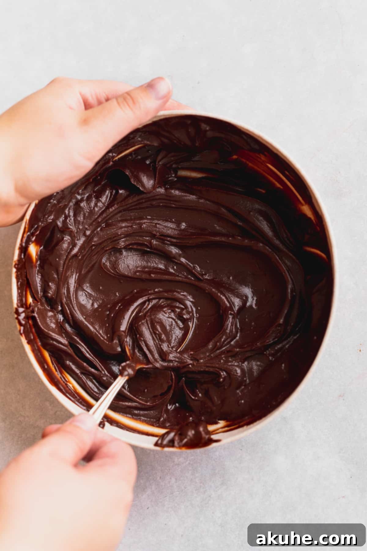 Decadent Chocolate Fudge Cupcakes 8 Luxurious chocolate ganache frosting resting in a bowl, showcasing its smooth, thick, and pipeable consistency.