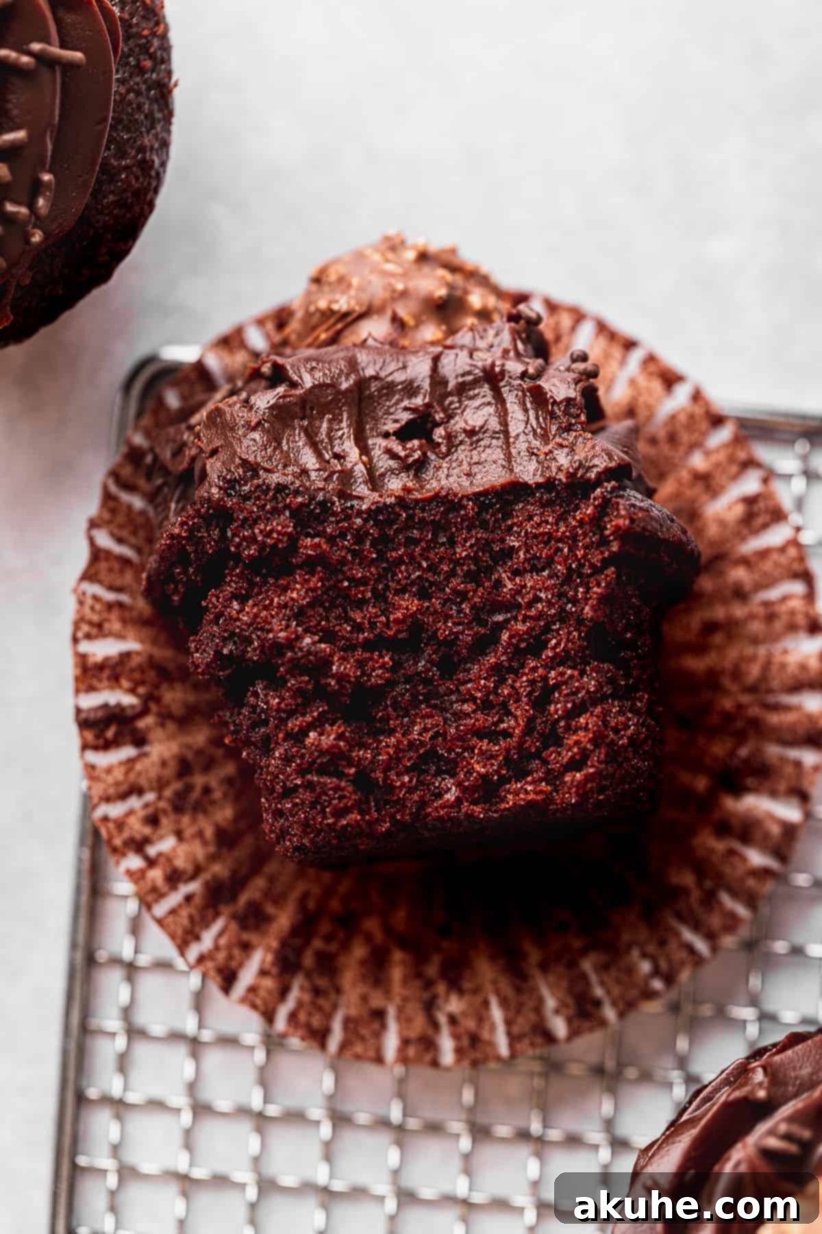 Decadent Chocolate Fudge Cupcakes 9 A delicious chocolate fudge cupcake with a bite taken out, showcasing its incredibly moist interior and rich ganache frosting.