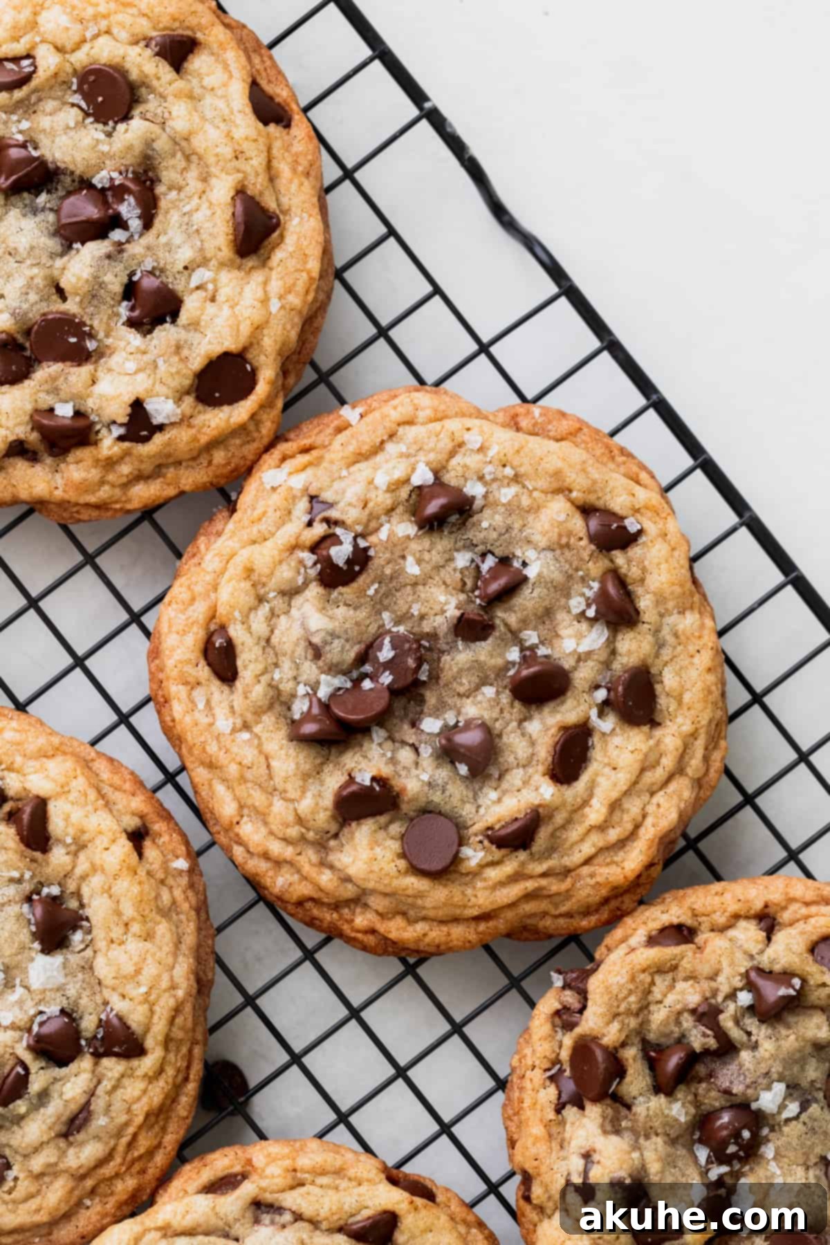 Ultimate Chocolate Chip Cookies 2 Deliciously gooey chocolate chip cookies cooling on a wire rack, showcasing their perfect chewy centers and crisp edges.