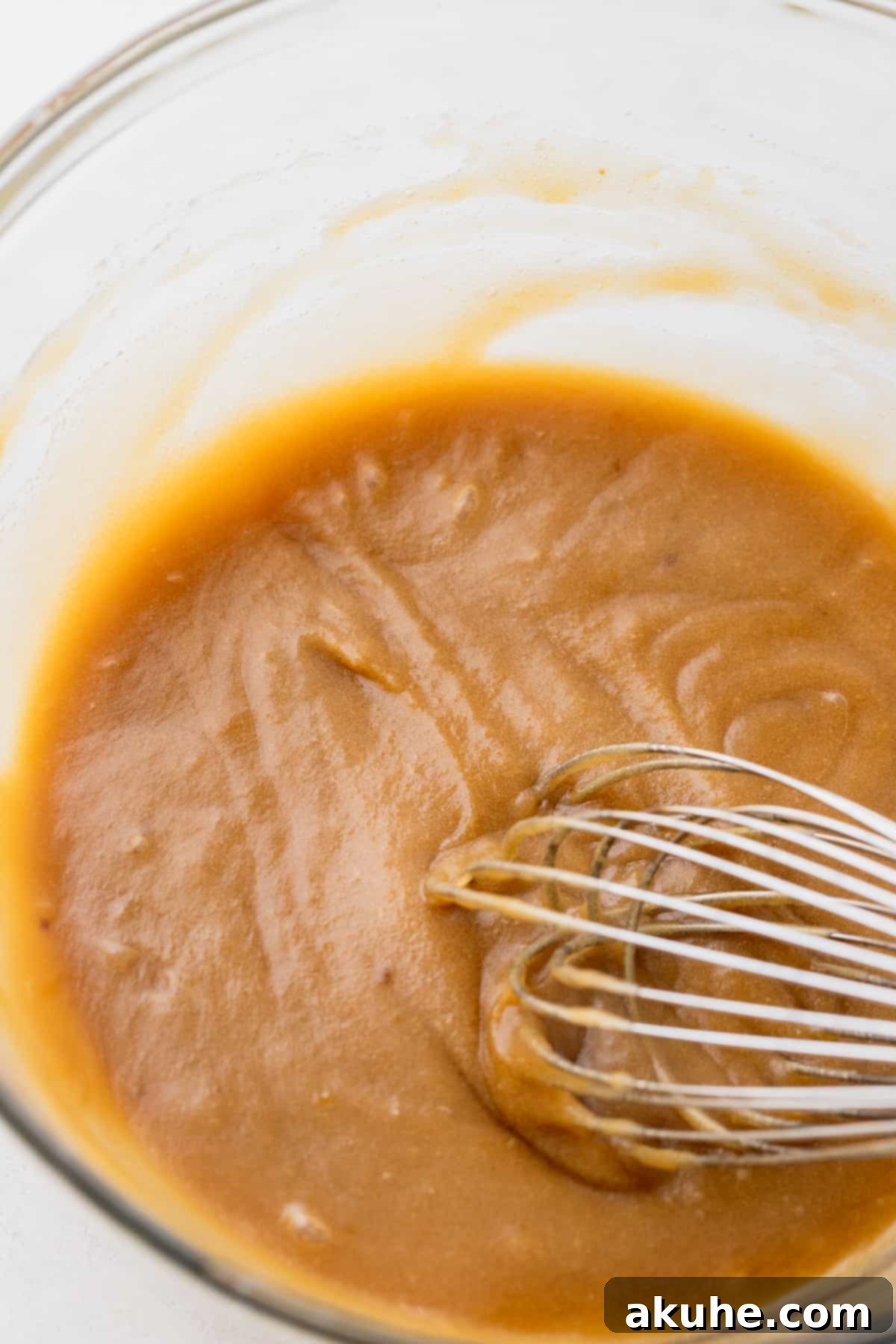 Ultimate Chocolate Chip Cookies 4 Wet ingredients being whisked together in a large glass bowl.