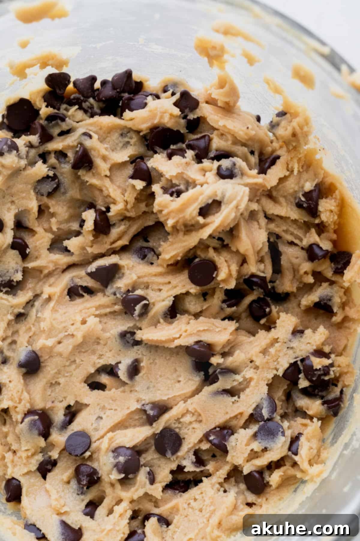 Ultimate Chocolate Chip Cookies 6 The fully mixed chocolate chip cookie dough resting in a glass bowl.