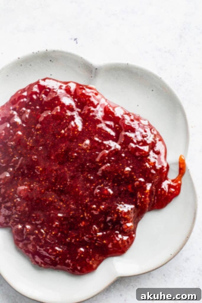 Nostalgic Peanut Butter and Jelly Cheesecake Bars 3 Freshly made homemade strawberry jam glistening on a white plate