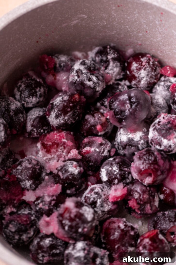 Homemade Cherry Pie Filling 4 A saucepan on a stove, containing fresh cherries, sugar, cornstarch, water, and almond extract, ready to be heated and transformed into a delicious filling.