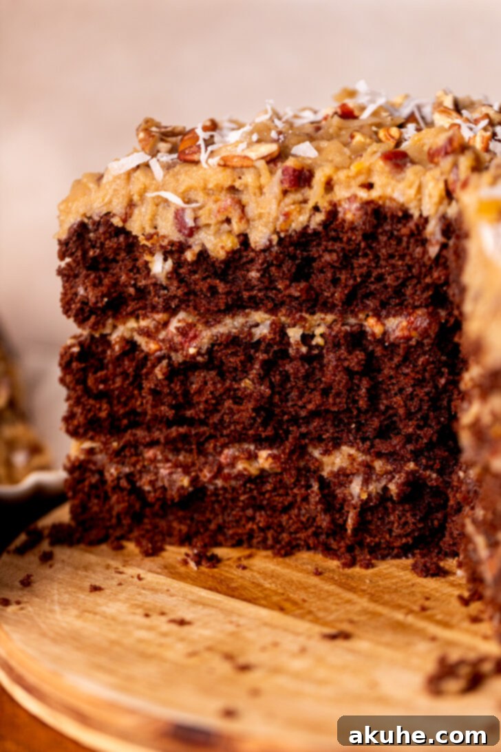 Decadent Chocolate Coconut Pecan Cake 2 Side view of a perfectly layered German chocolate cake, showcasing its rich chocolate cake and abundant coconut pecan frosting.