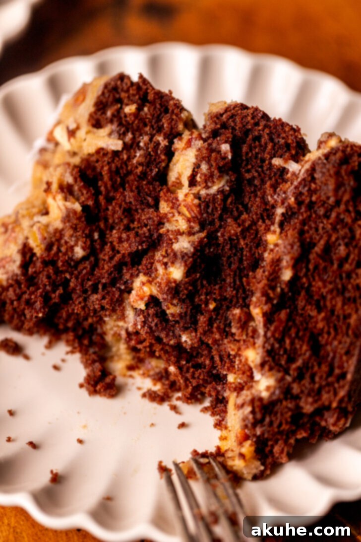 Decadent Chocolate Coconut Pecan Cake 11 A delectable slice of German chocolate cake with a bite missing, showcasing its irresistible texture and flavor.