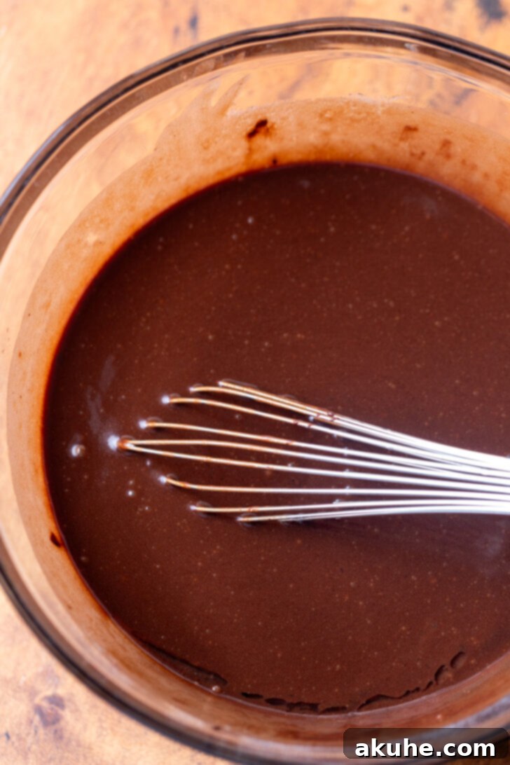 Decadent Chocolate Coconut Pecan Cake 4 Wet ingredients in a mixing bowl, ready to be combined with other components for the chocolate cake batter.