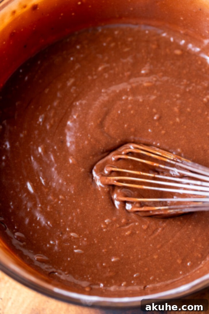 Decadent Chocolate Coconut Pecan Cake 5 Smooth, rich chocolate cake batter in a bowl, perfectly mixed and ready for baking.