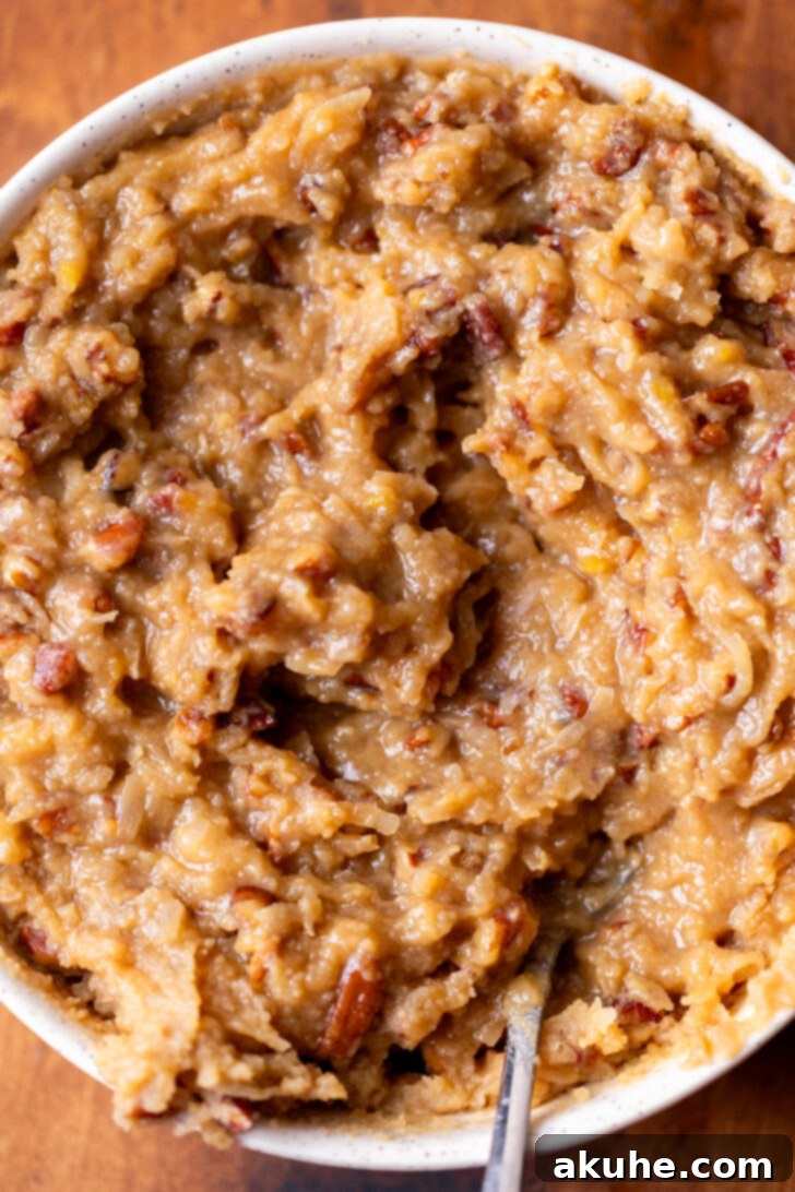 Decadent Chocolate Coconut Pecan Cake 8 A bowl filled with the rich, thick coconut pecan frosting, perfectly textured and ready to be spread.