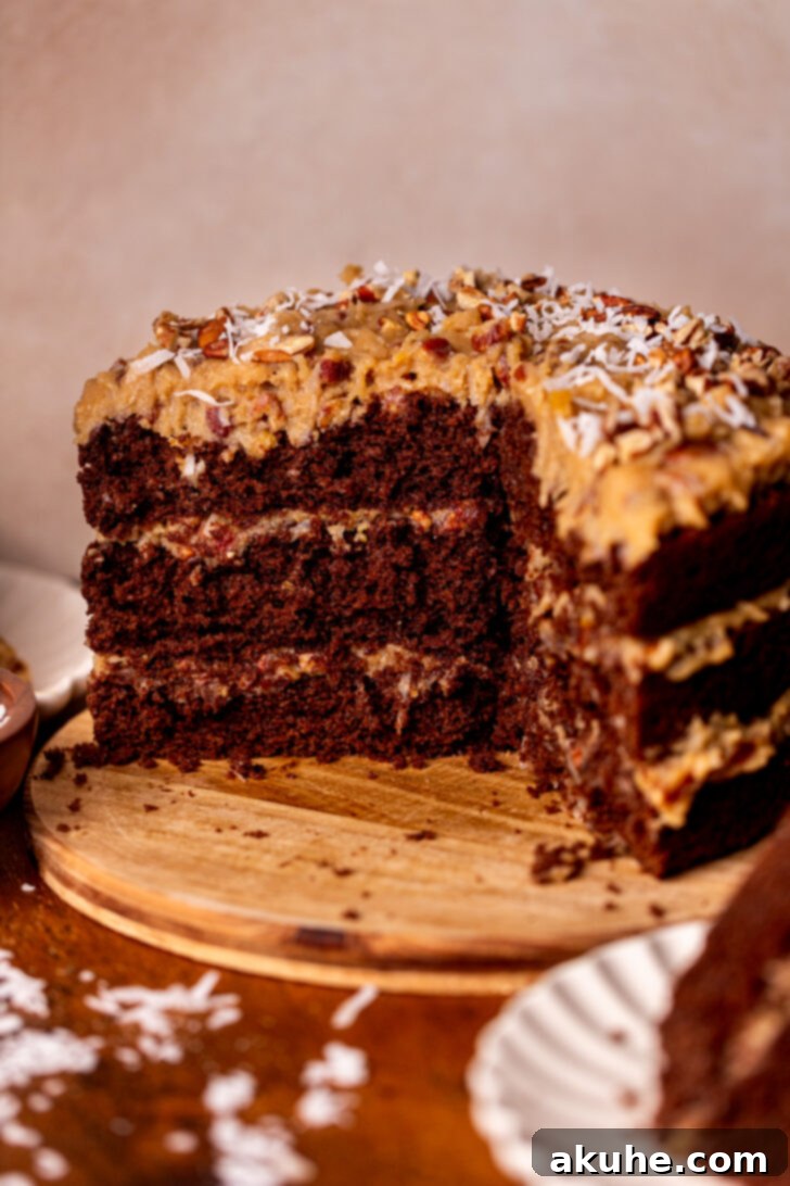 Decadent Chocolate Coconut Pecan Cake 10 The stunning finished German chocolate cake, beautifully frosted and presented on a rustic wood board.