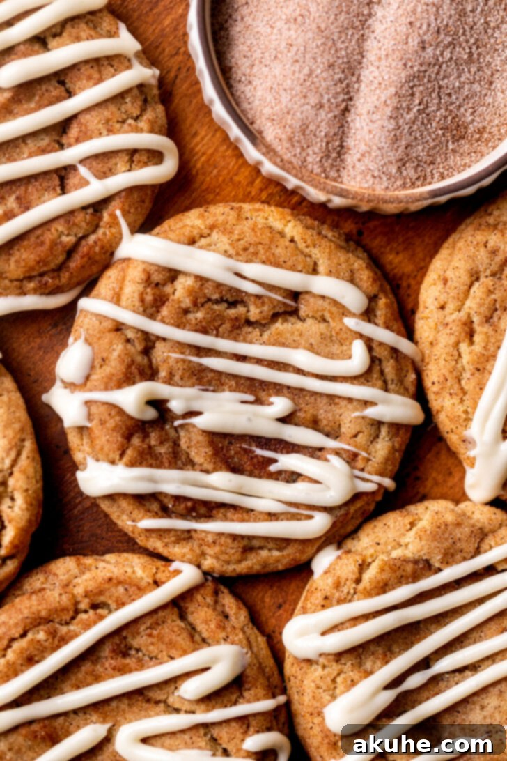 Top view of freshly baked cinnamon roll cookies drizzled with cream cheese icing.