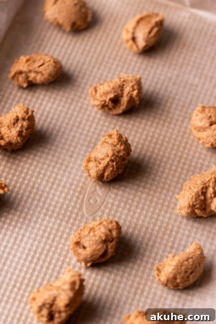 Small dollops of cinnamon filling arranged on a cookie sheet lined with wax paper.