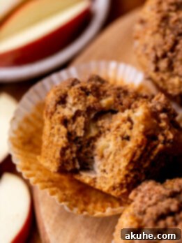 Golden Apple Muffins 11 Perfectly baked apple muffin with a bite taken out, revealing the soft, apple-filled interior.