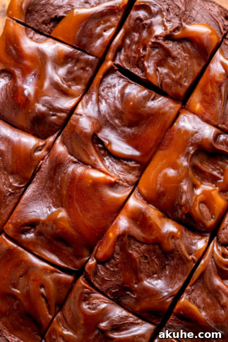 Decadent Chocolate Caramel Dream 3 Rich, glossy caramel gracefully swirled on top of velvety chocolate cream cheese frosting on a homemade chocolate caramel cake, ready to be presented.