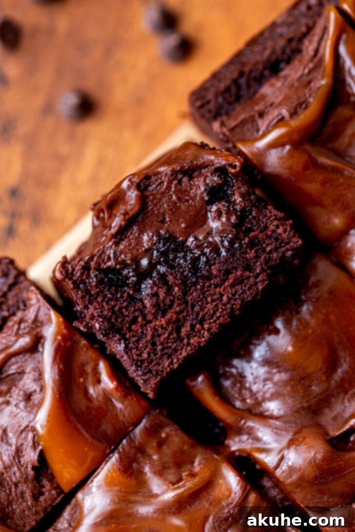 Decadent Chocolate Caramel Dream 9 One perfectly cut slice of chocolate caramel cake lying on its side, elegantly presenting the dense chocolate cake layers and visible caramel infusion.