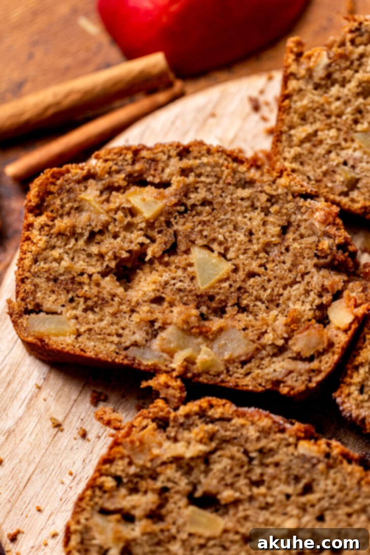 Spiced Apple Bread 2 Close-up of a perfectly baked slice of homemade apple bread, showcasing the cinnamon swirl and tender apple chunks.