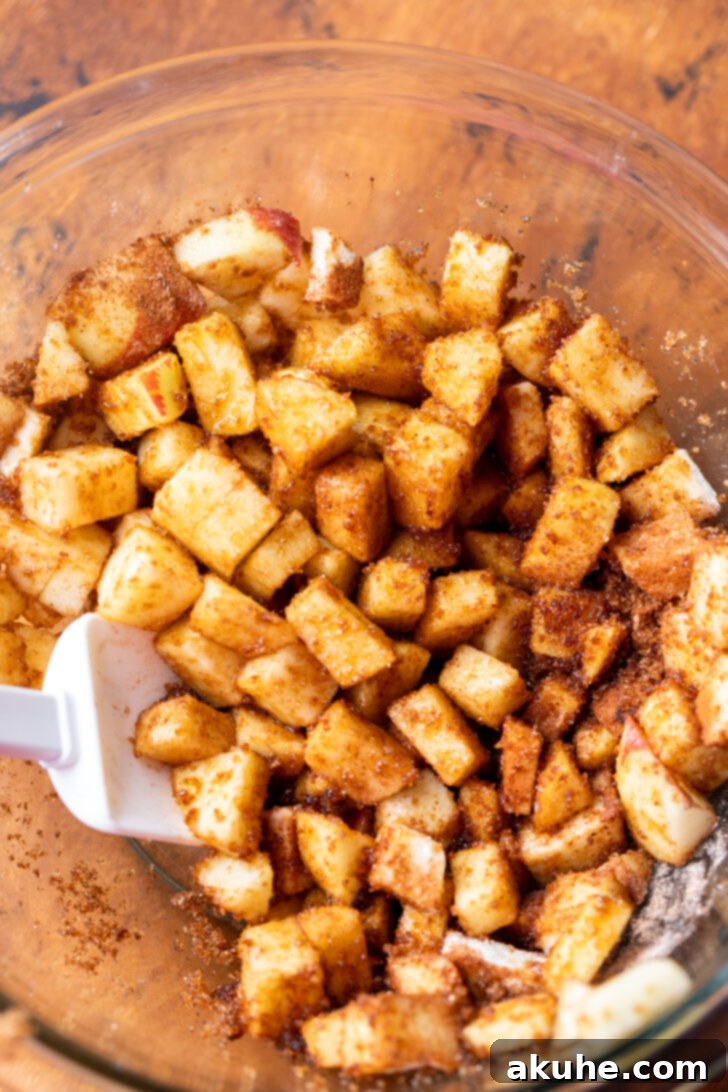 Spiced Apple Bread 4 Diced Gala apples coated in cinnamon, brown sugar, and a touch of flour, ready to be folded into the bread batter.