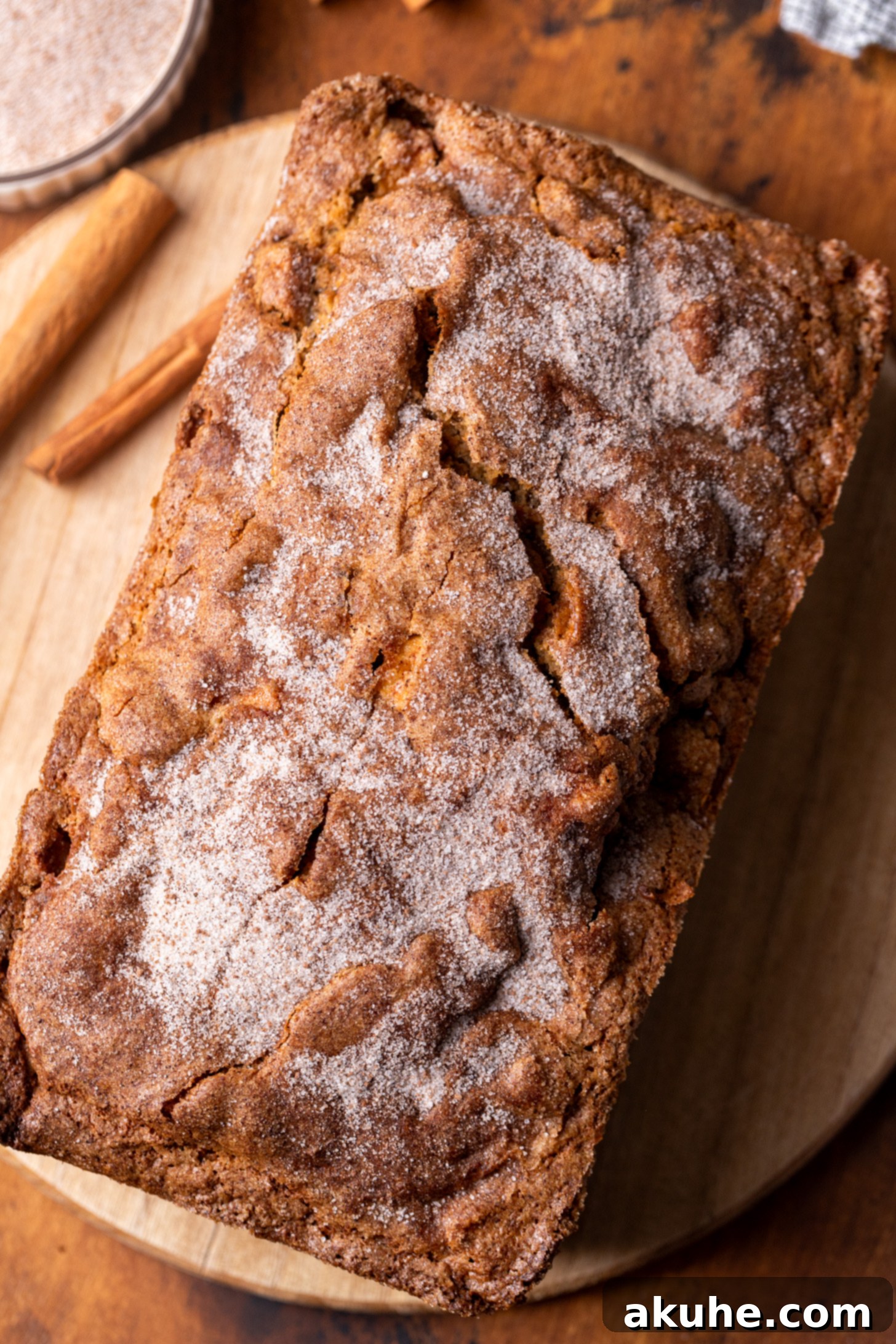 Spiced Apple Bread 6 A freshly baked, golden-brown apple bread loaf cooling on a wire rack after its long bake time, reminiscent of banana bread.