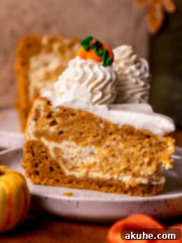 Autumn Pumpkin Cheesecake Cake 12 One slice of pumpkin cheesecake cake on a plate.