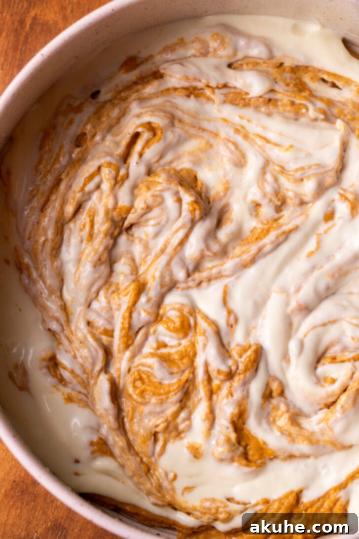 Autumn Pumpkin Cheesecake Cake 6 Bottom layer of pumpkin cake and cheesecake swirled together in a pan.