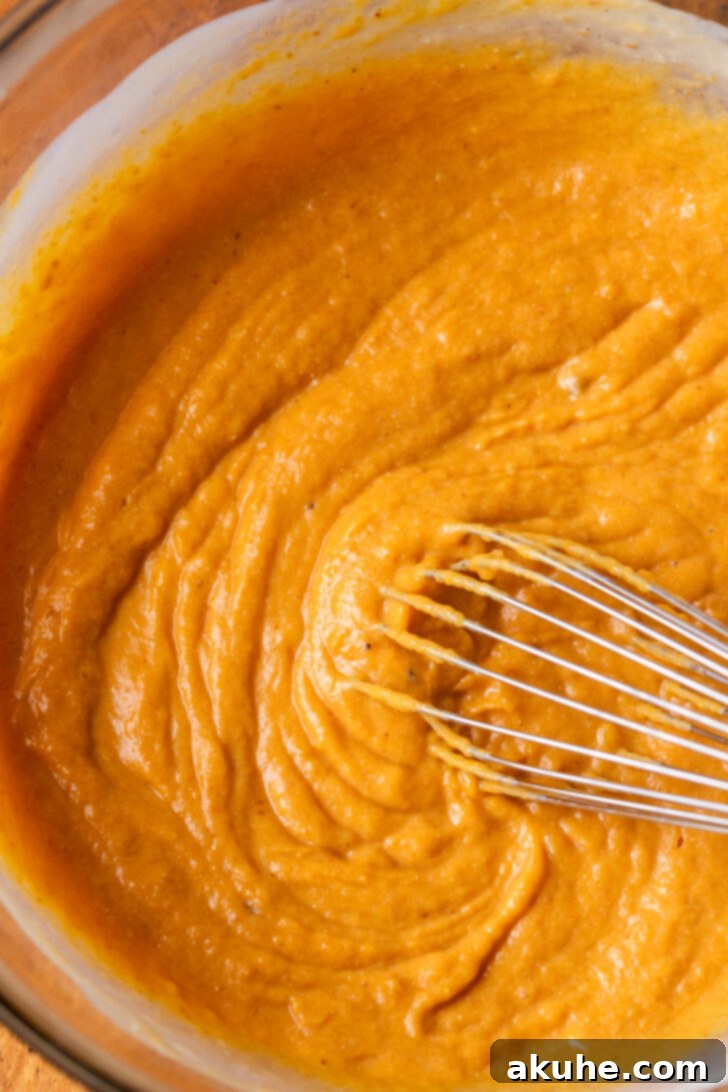 Warm Spiced Pumpkin Pancakes 4 Wet ingredients in a bowl, showcasing egg, buttermilk, and milk.