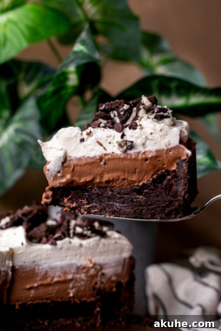 Deep South Chocolate Decadence 2 A perfect slice of Mississippi Mud Pie being taken from the whole pie, showcasing its distinct layers.