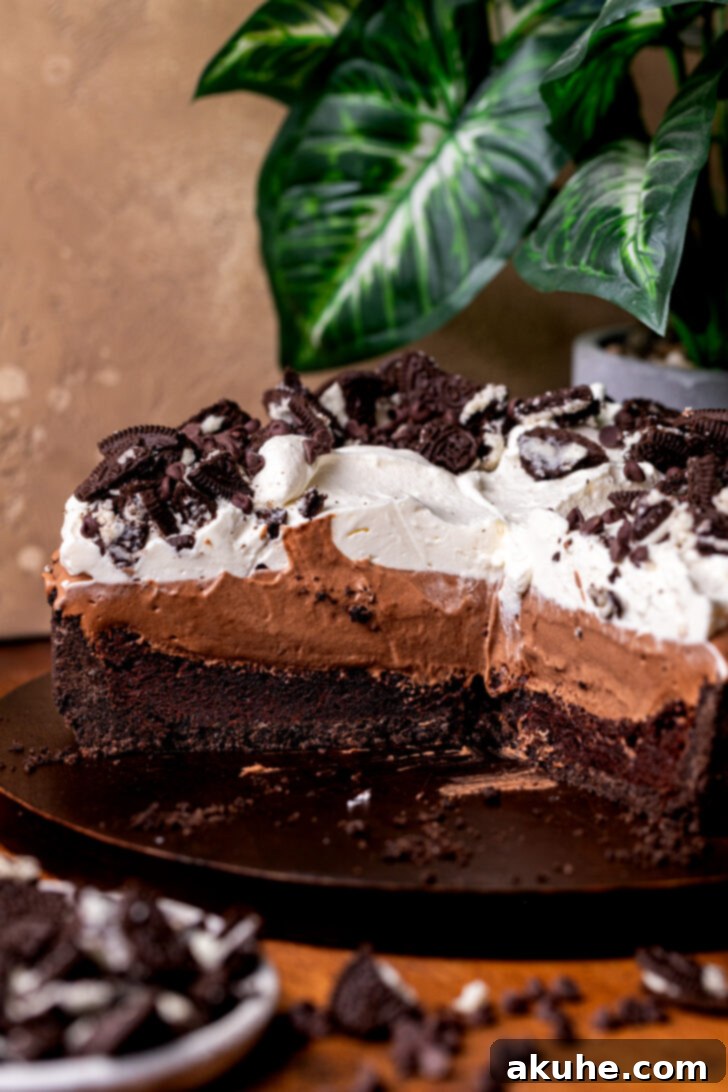 Deep South Chocolate Decadence 3 A Mississippi Mud Pie, artfully split open to reveal its luscious layers, resting on a rustic wooden board.