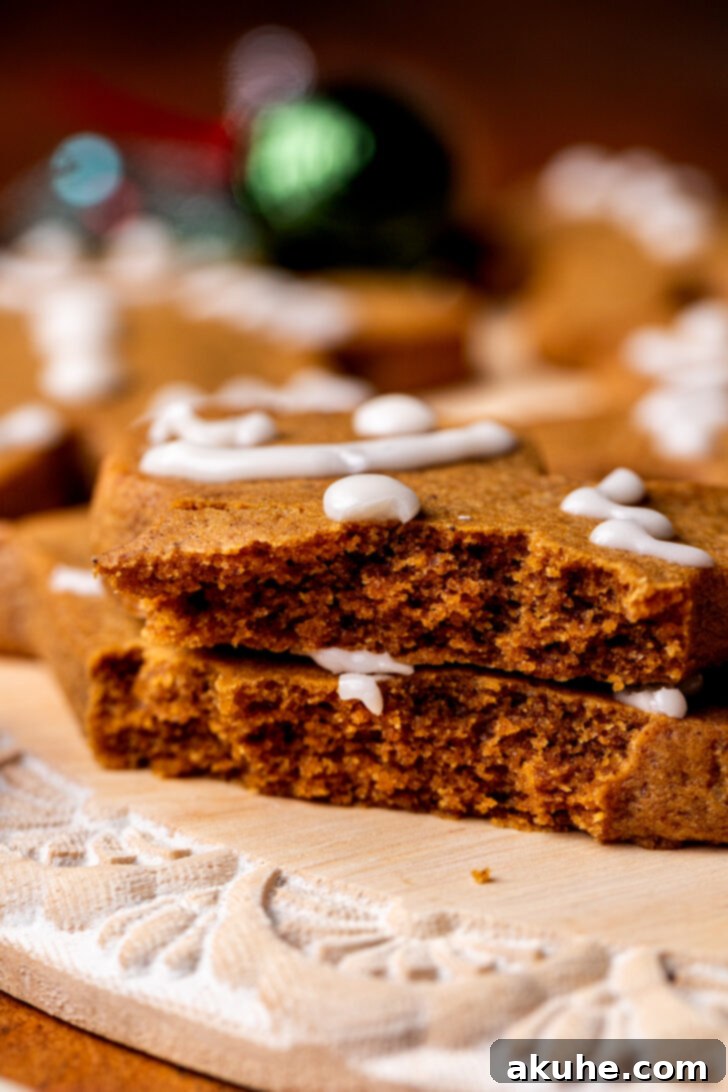 Irresistibly Soft Gingerbread 3 A stack of two soft gingerbread cookies, broken in half to reveal their moist, chewy interior.