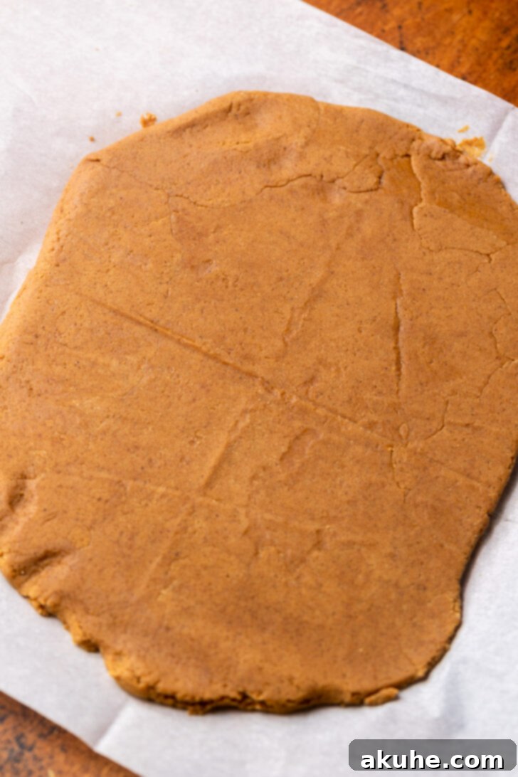 Irresistibly Soft Gingerbread 6 Gingerbread cookie dough rolled out evenly between two sheets of parchment paper.