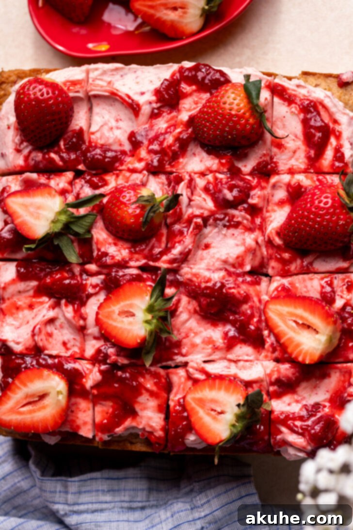 Perfect Fresh Strawberry Cake 11 A top-down view of the beautifully decorated strawberry cake with jam swirls, resting before slicing.