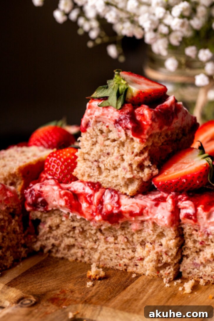 Perfect Fresh Strawberry Cake 13 A stack of delicious strawberry cake slices, highlighting the layers of cake, frosting, and jam.