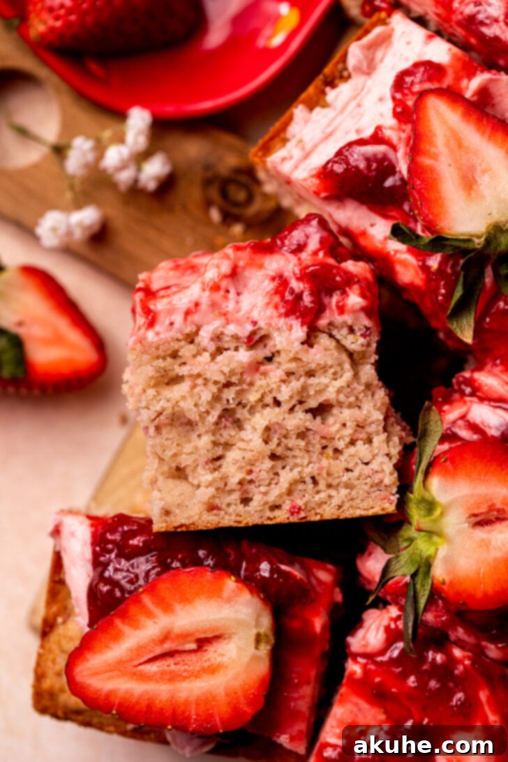 Perfect Fresh Strawberry Cake 3 A single, perfectly cut slice of strawberry cake, revealing the moist layers and the vibrant jam swirl, placed elegantly on its side.