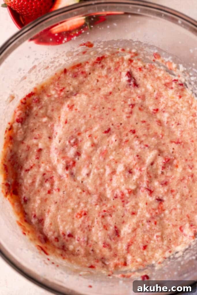 Perfect Fresh Strawberry Cake 4 Close-up view of wet ingredients, including lightly pureed strawberries, in a mixing bowl before combining with dry ingredients.