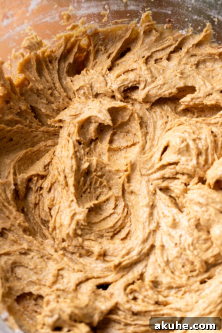 Warm Gingerbread Delights 4 Thick, spiced gingerbread cupcake batter in a mixing bowl, ready for baking.