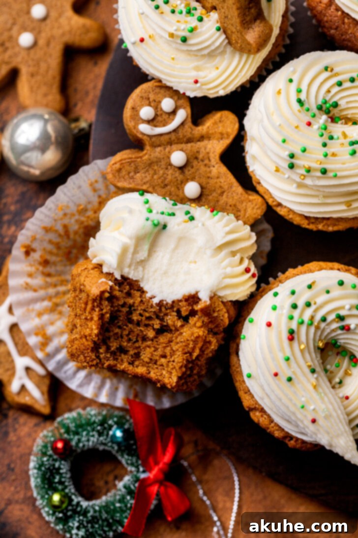 Warm Gingerbread Delights 9 Overhead view of festive gingerbread cupcakes, one with a bite missing, showcasing its deliciousness.