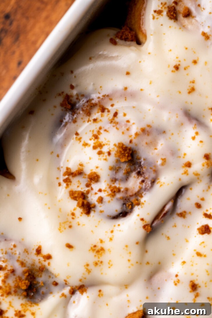 Festive Eggnog Swirls 2 Top view of eggnog cinnamon rolls, generously iced and ready to be enjoyed.