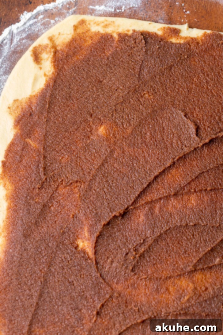 Festive Eggnog Swirls 5 Spreading the rich cinnamon filling evenly over the rolled-out eggnog dough.