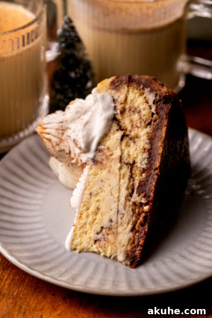 Eggnog Dream Cheesecake 10 One slice of cheesecake on a plate on its side.
