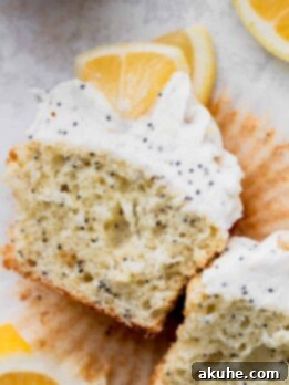 Sunshine Lemon Poppy Seed Cupcakes 11 Lemon poppy seed cupcakes split in half, showcasing the vibrant lemon crumb and poppy seeds.