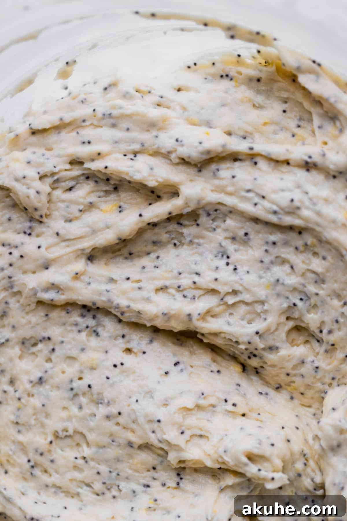 Sunshine Lemon Poppy Seed Cupcakes 5 Close-up of lemon poppy seed cupcake batter in a mixing bowl, ready for baking.