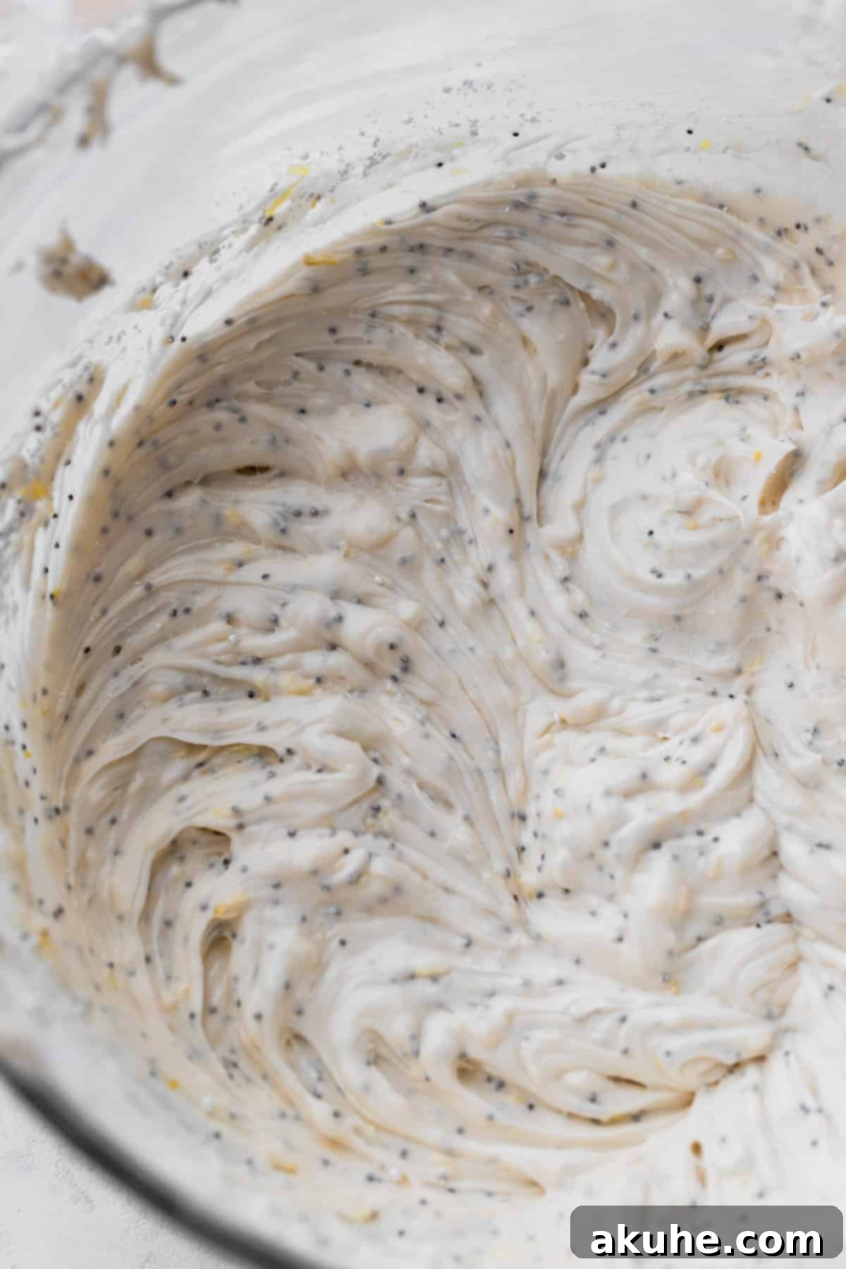 Sunshine Lemon Poppy Seed Cupcakes 8 Smooth and fluffy lemon cream cheese frosting in a glass mixing bowl.