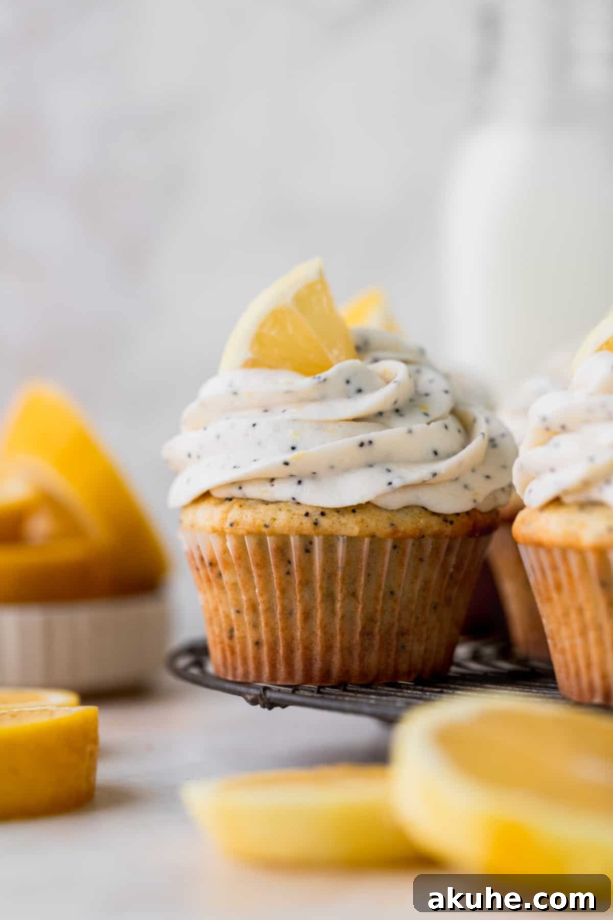 Sunshine Lemon Poppy Seed Cupcakes 9 A batch of delicious lemon poppy seed cupcakes neatly arranged on a wire cooling rack, ready for frosting.