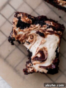 Decadent Marshmallow Brownies 12 One bite missing from marshmallow brownies.