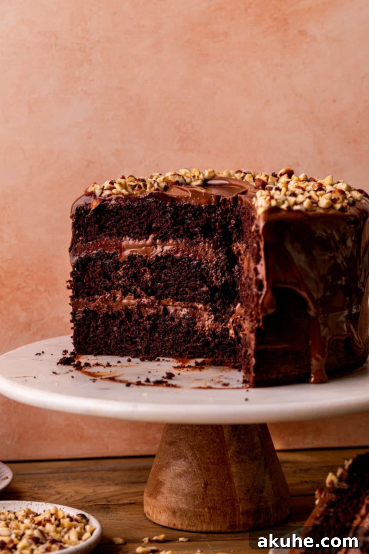A beautifully frosted Nutella cake on a elegant cake stand, ready to be served.