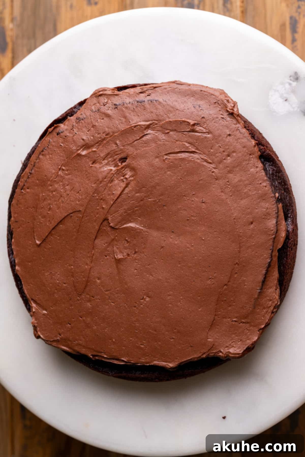 Top of Nutella cake with a border of Nutella frosting, ready for the filling.