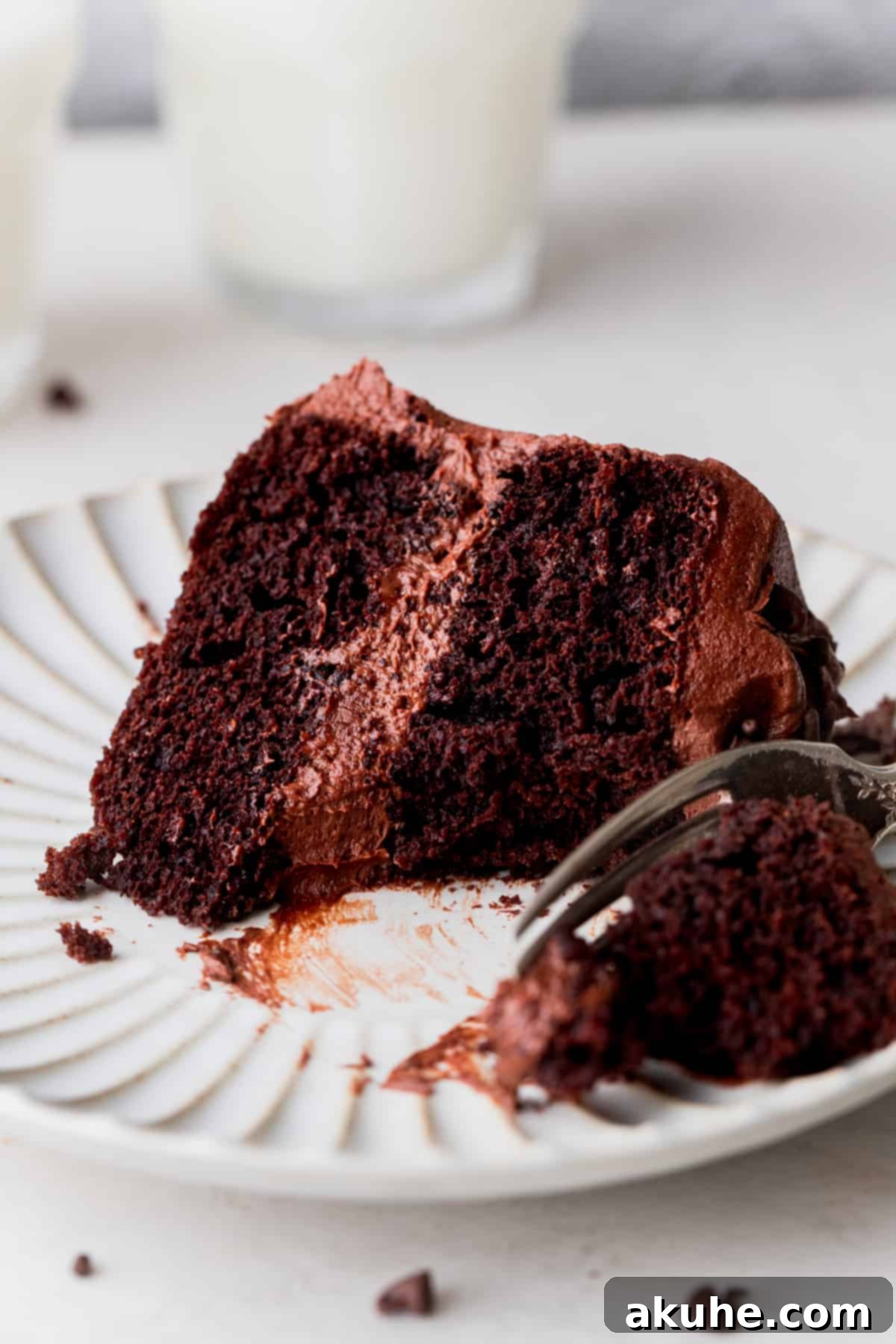 Plate with a missing bite of mini chocolate cake.