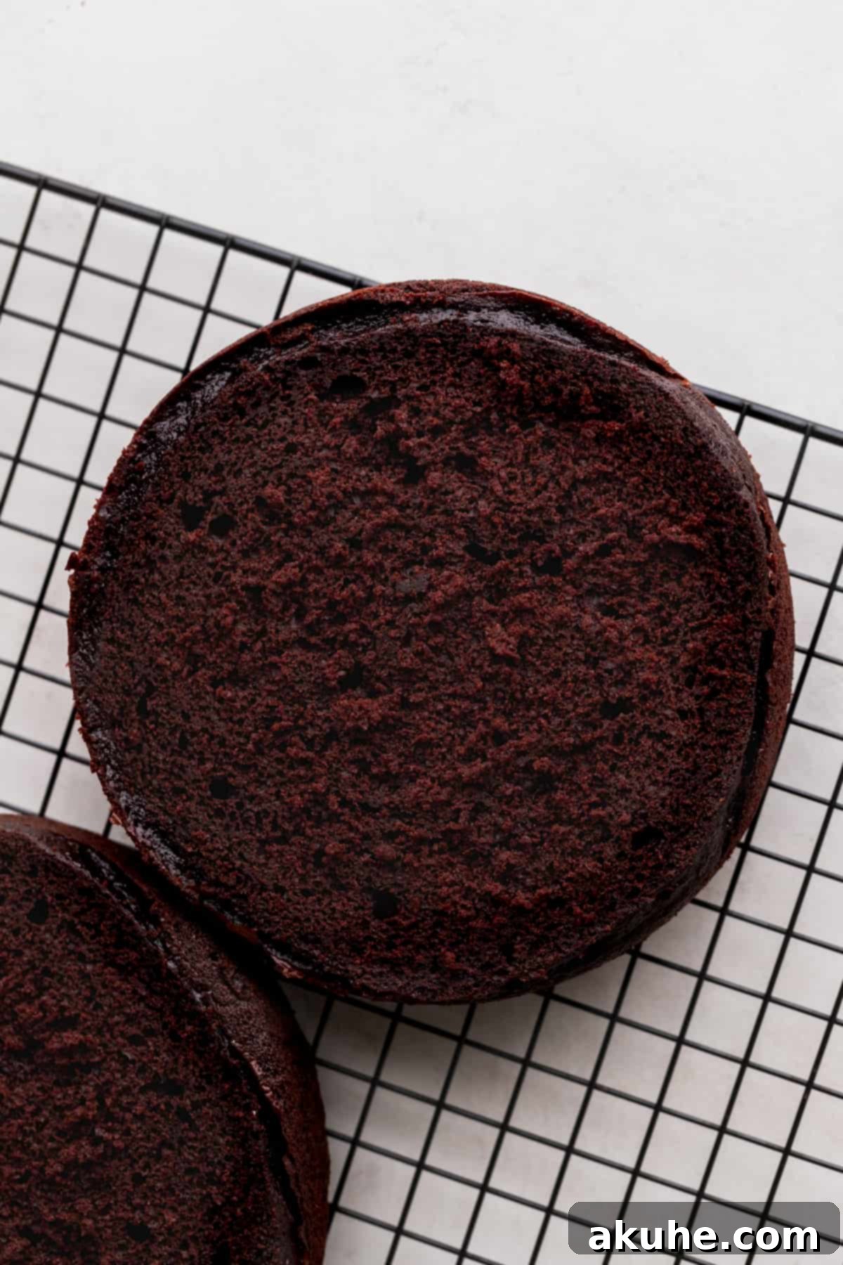 Cooling chocolate cake layers on a wire rack.